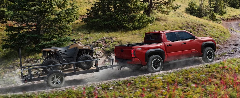 Exterior of 2025 Toyota Tacoma towing up a hill.