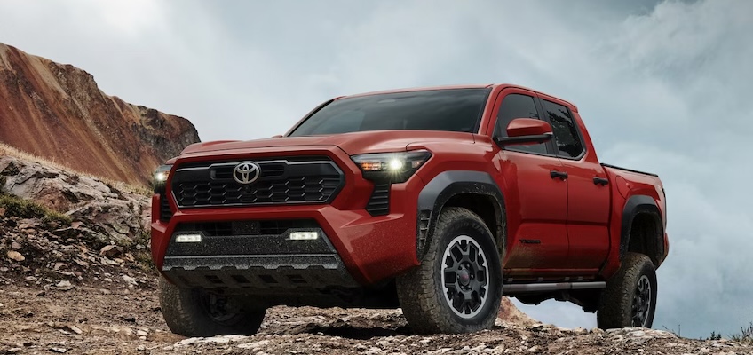 Exterior of red 2025 Toyota Tacoma on mountain.