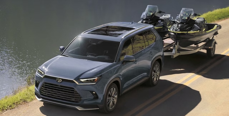 Exterior of the 2025 Toyota Grand Highlander towing two jet skis.