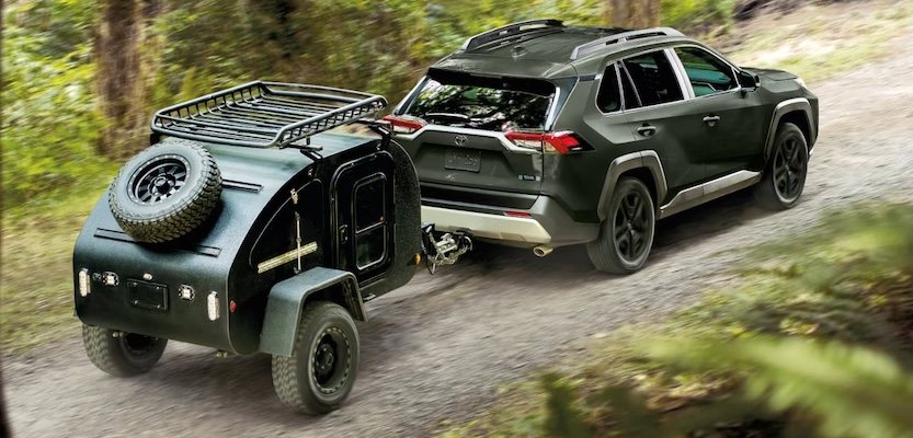 Exterior of 2025 Toyota RAV4 towing up a mountain.