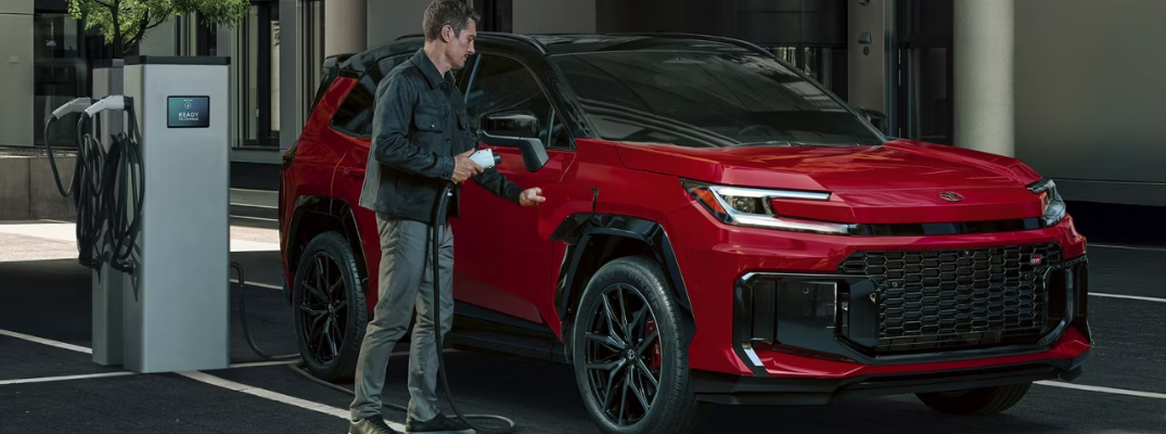 Man charging the 2026 Toyota RAV4 Plug-in Hybrid